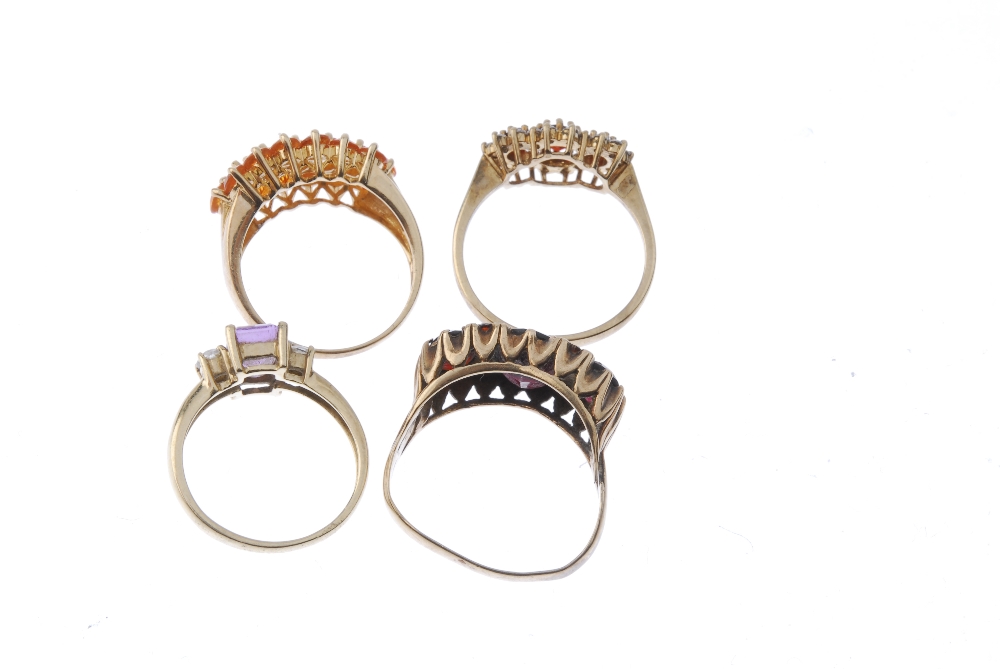 A selection of four 9ct gold gem-set rings. To include a fire opal dress ring, an amethyst and cubic - Image 4 of 4