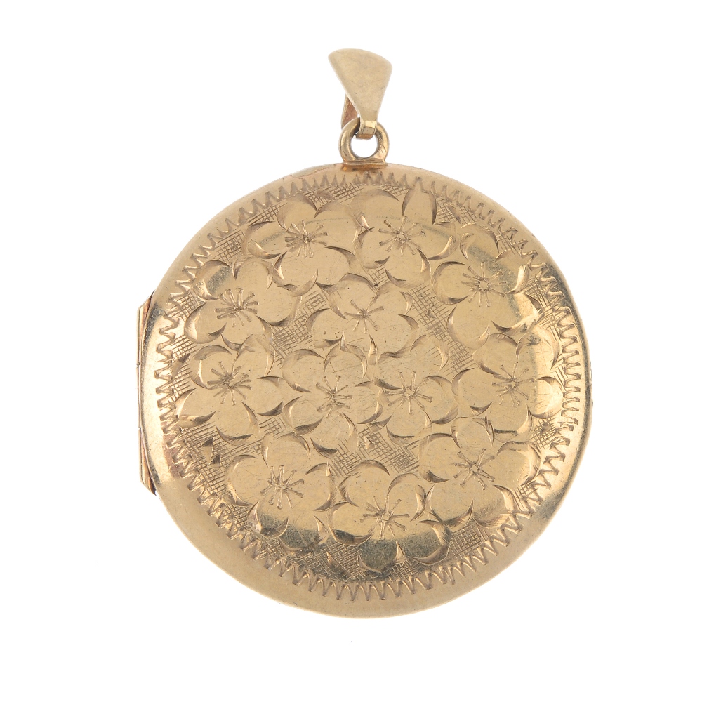 A 1970s 9ct gold locket. Of circular outline, the foliate front, with plain back and tapered