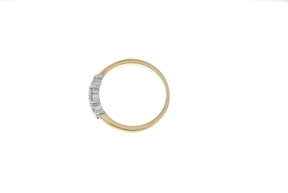 An 18ct gold diamond three-stone ring. The slightly graduated brilliant-cut diamond line, with bar - Image 3 of 4