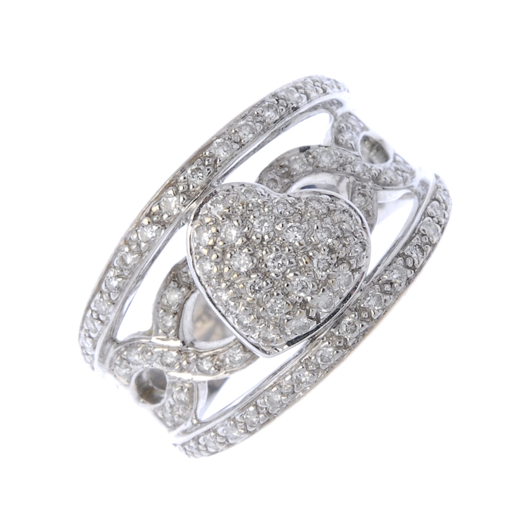 A diamond dress ring. Designed as a brilliant-cut diamond heart-shape panel, to the similarly-cut