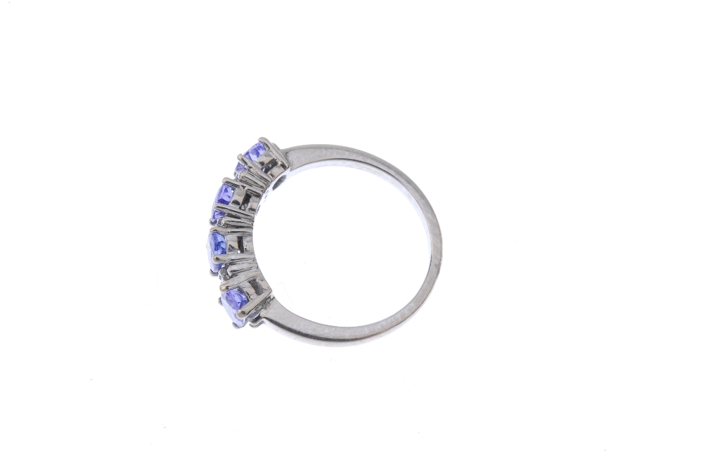 An 18ct gold tanzanite and diamond ring. The oval-shape tanzanite line, interspaced by single-cut - Image 3 of 4