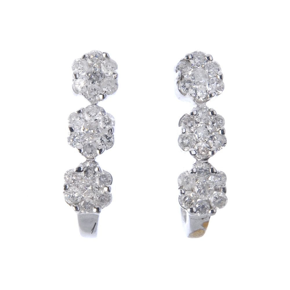 A pair of diamond floral earrings and pendant. To include a pair of diamond earrings, each