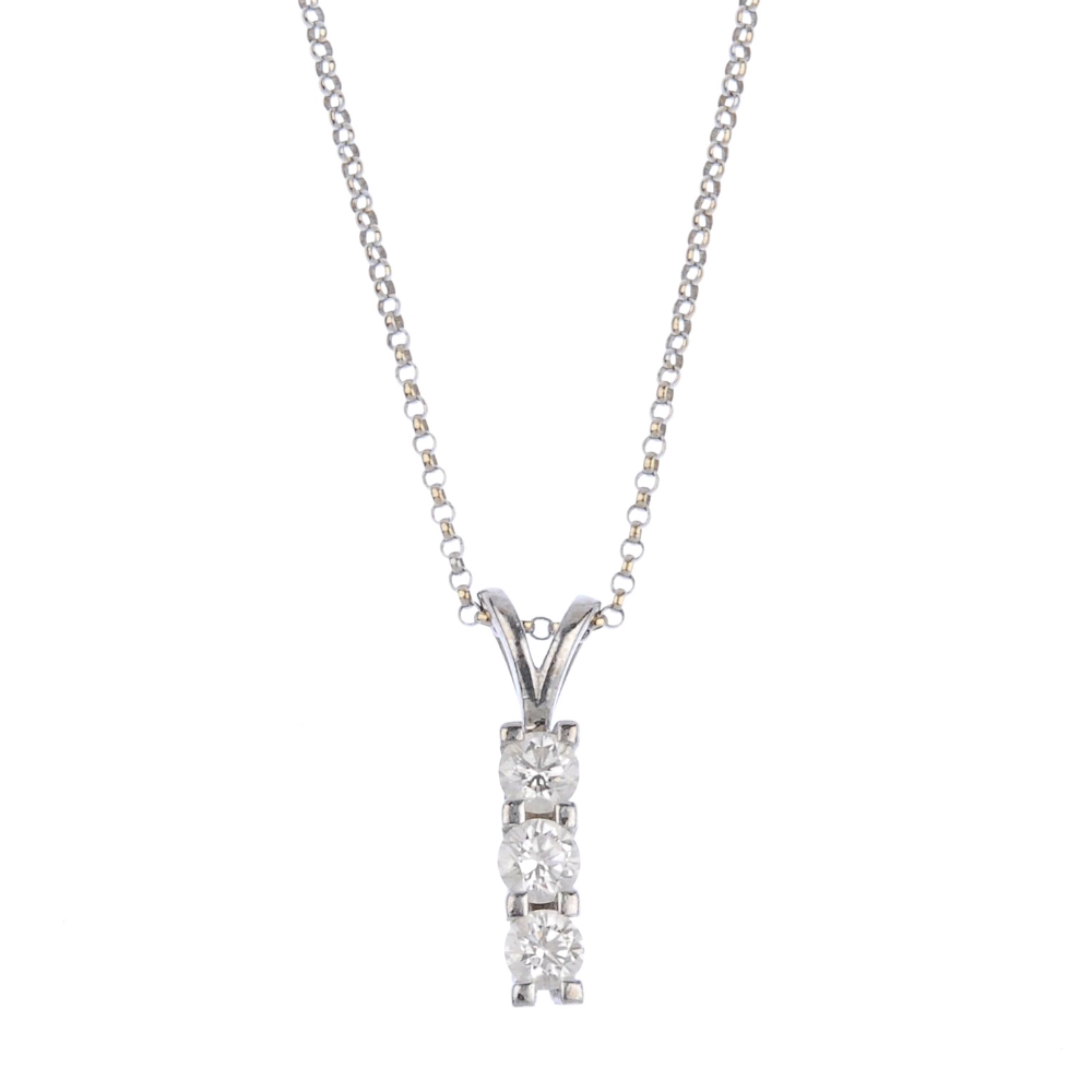 (57564) An 18ct gold diamond three-stone pendant. Designed as a line of three brilliant-cut