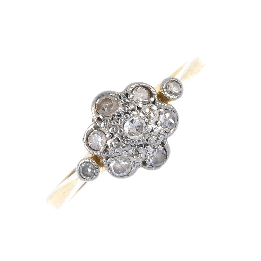 A mid 20th century platinum and 18ct gold diamond cluster ring. The single-cut diamond floral