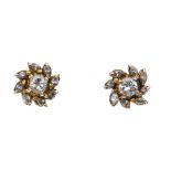 Two pairs of diamond ear studs. The first pair each designed as a brilliant-cut and marquise-shape