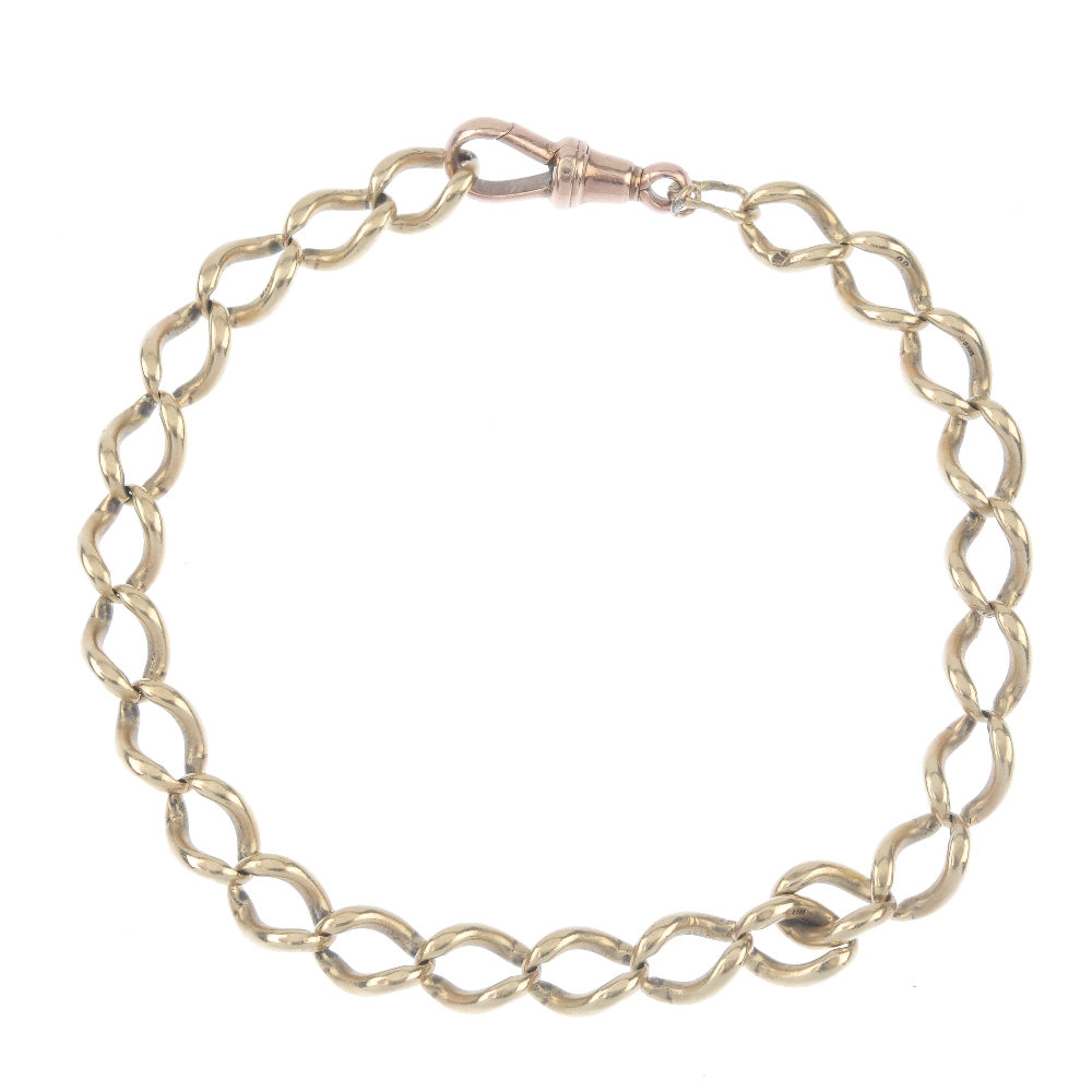 A 9ct gold curb-link bracelet. Designed as a series of elongated curb-links, to the replacement