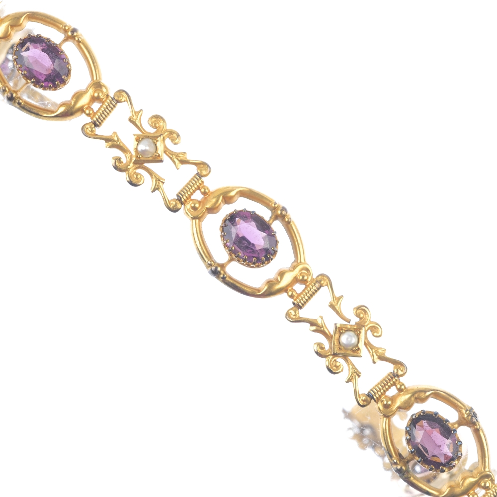 An early 20th century gold garnet-topped-doublet and split pearl bracelet. Of scrolling design,