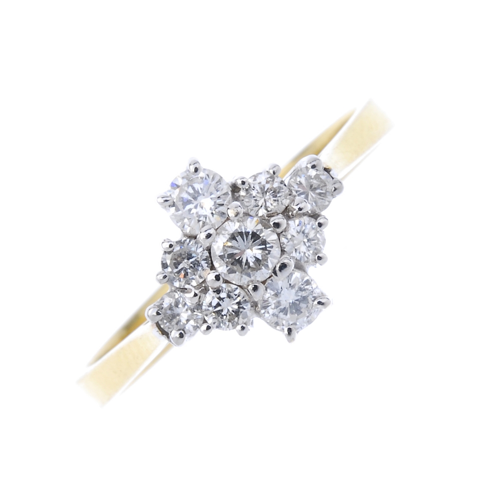An 18ct gold diamond cluster ring. Of marquise-shape outline, the brilliant-cut diamond line, with