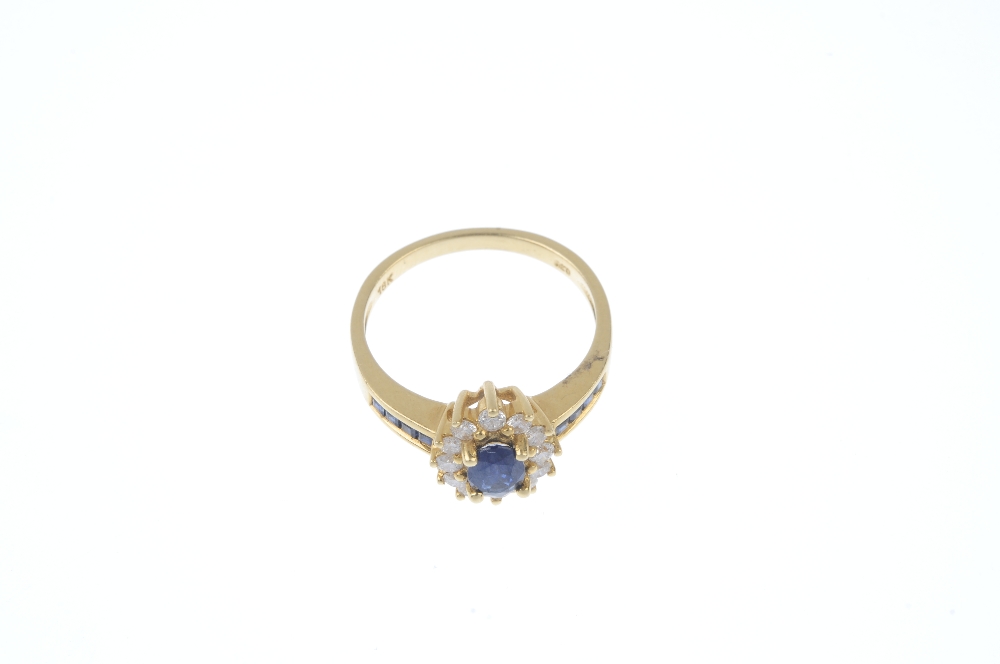 An 18ct gold sapphire and diamond cluster ring. The oval-shape sapphire, within a brilliant-cut - Image 2 of 4