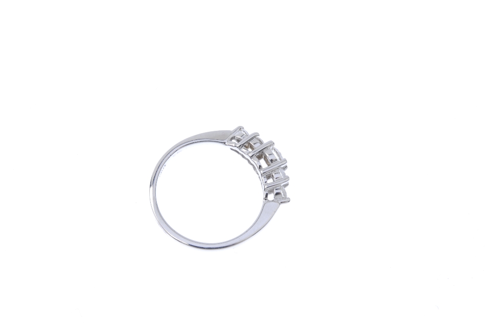 A diamond five-stone ring. The graduated brilliant-cut diamond stepped line, to the tapered - Image 4 of 4