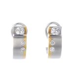 A pair of 18ct gold diamond ear hoops. Each of bi-colour design, comprising a tension-set