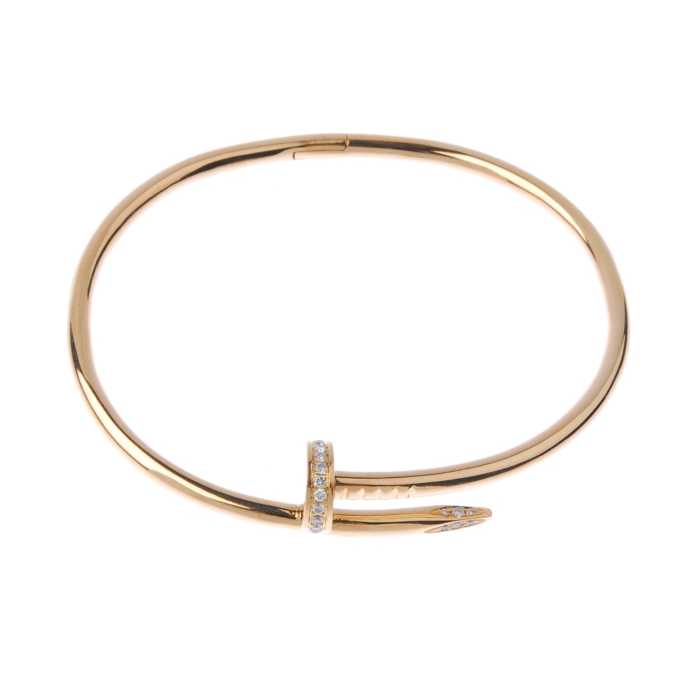 (541392-2-A) CARTIER - a diamond 'juste en clou' bangle. The hinged bangle, with brilliant-cut