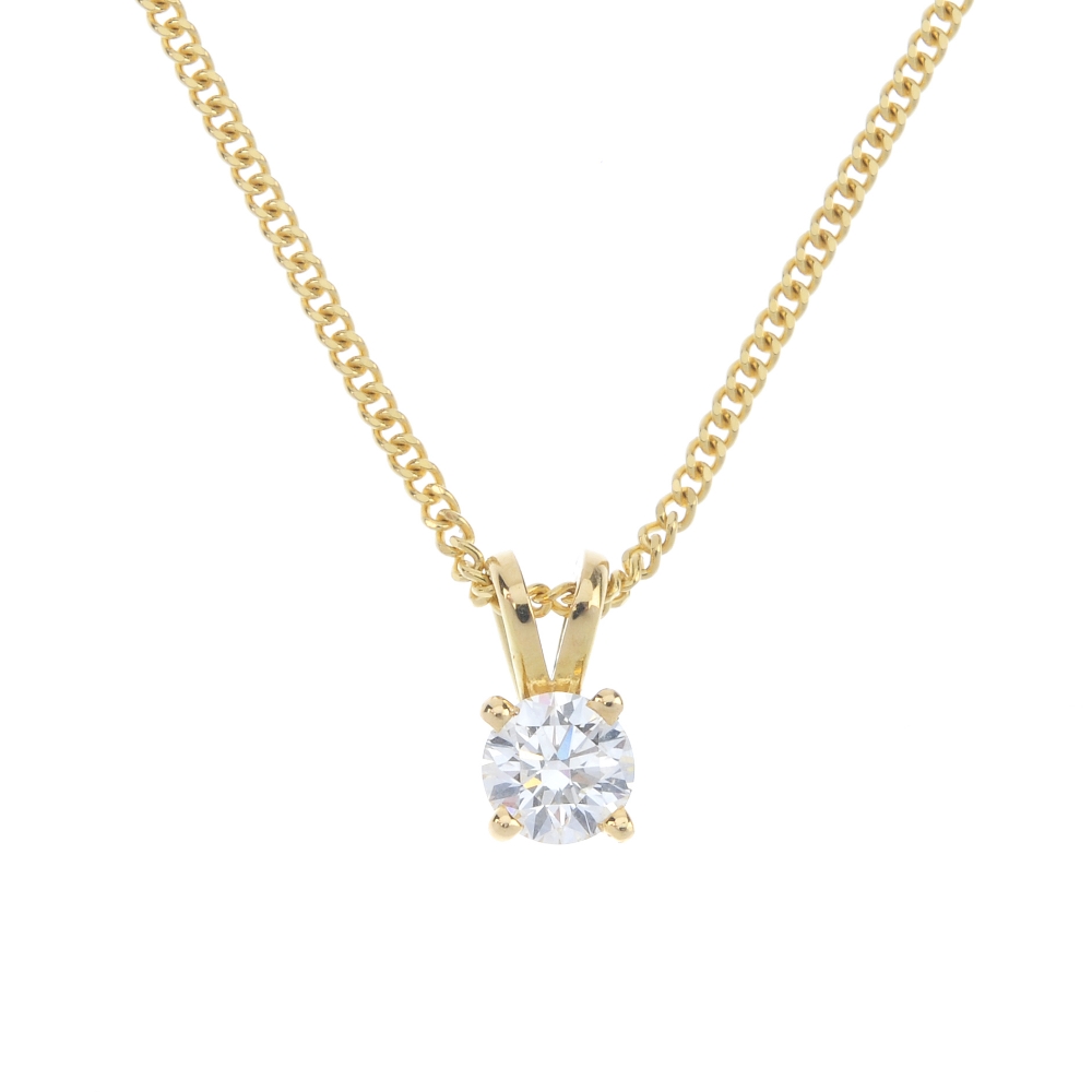 A diamond single-stone pendant. The brilliant-cut diamond, with bifurcated surmount, suspended