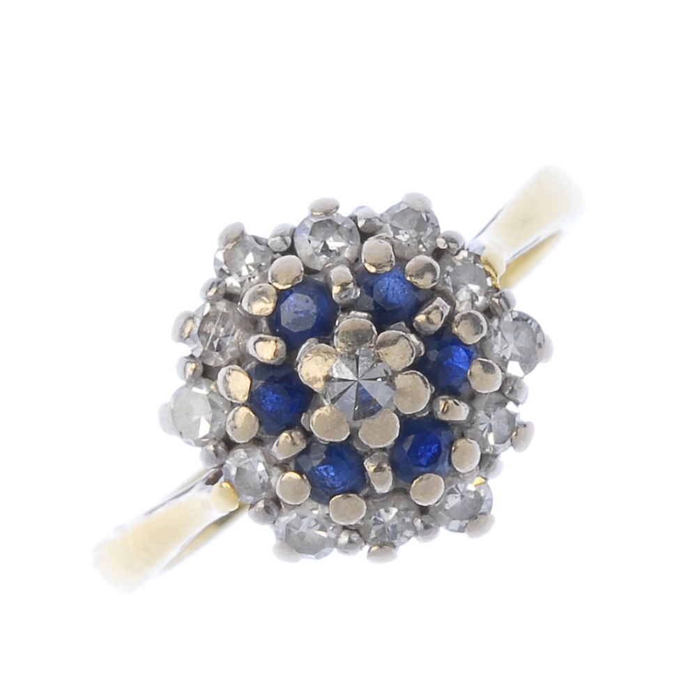 A sapphire and diamond cluster ring. The single-cut diamond and circular-shape sapphire tiered