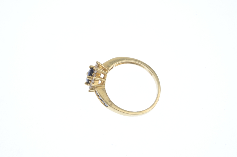 An 18ct gold sapphire and diamond cluster ring. The oval-shape sapphire, within a brilliant-cut - Image 3 of 4