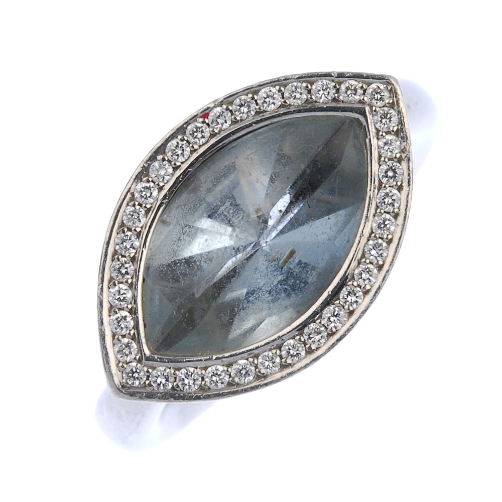 (161740) An aquamarine and diamond dress ring. Designed as a marquise-shape aquamarine within a