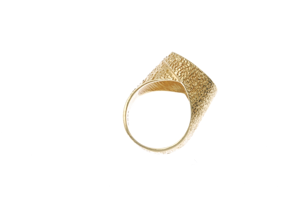 A 1970s 18ct gold textured dress ring. Of textured design, the overlapping panels, forming a central - Image 4 of 4