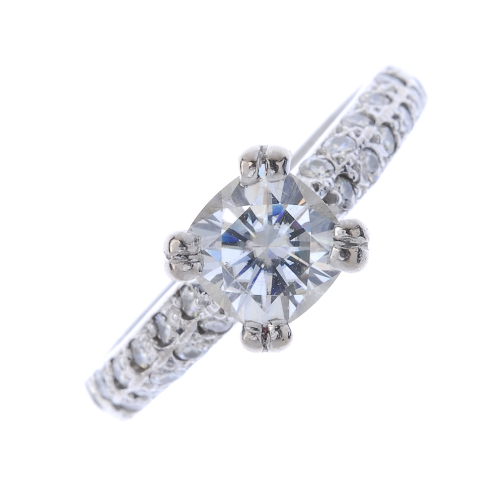 An 18ct gold moissanite single-stone ring. The circular-shape moissonite, to the pave-set