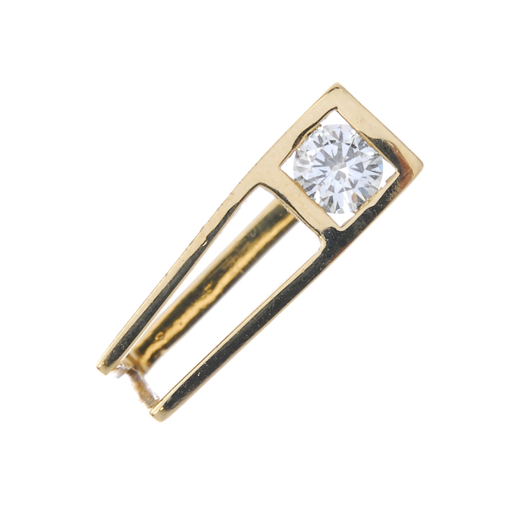 An 18ct gold diamond single-stone ring. Of geometric design, the brilliant-cut diamond, to the