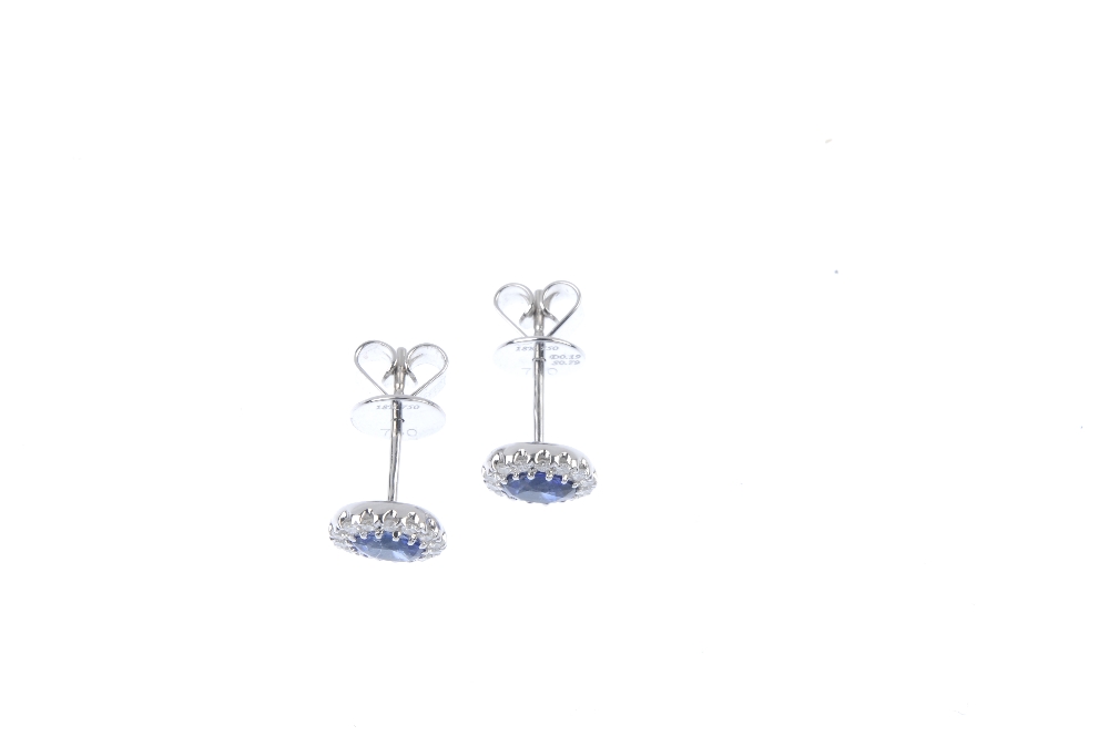 * A pair of sapphire and diamond cluster ear studs. Each designed as an oval-shape sapphire, - Image 2 of 2