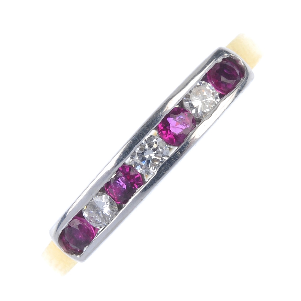 An 18ct gold ruby and diamond seven-stone ring. The alternating circular-shape ruby and brilliant-