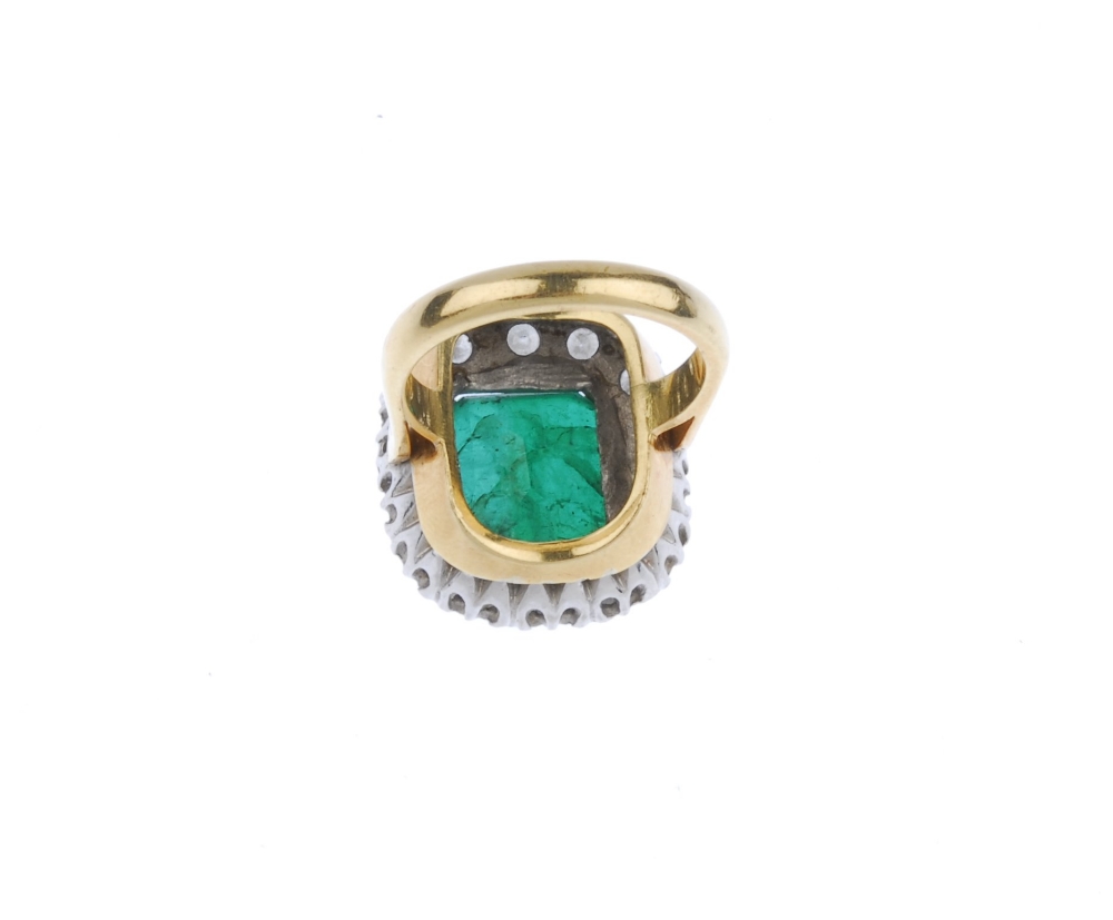 (539356-1-A) An 18ct gold emerald and diamond cluster ring. The rectangular-shape emerald, within - Image 2 of 4