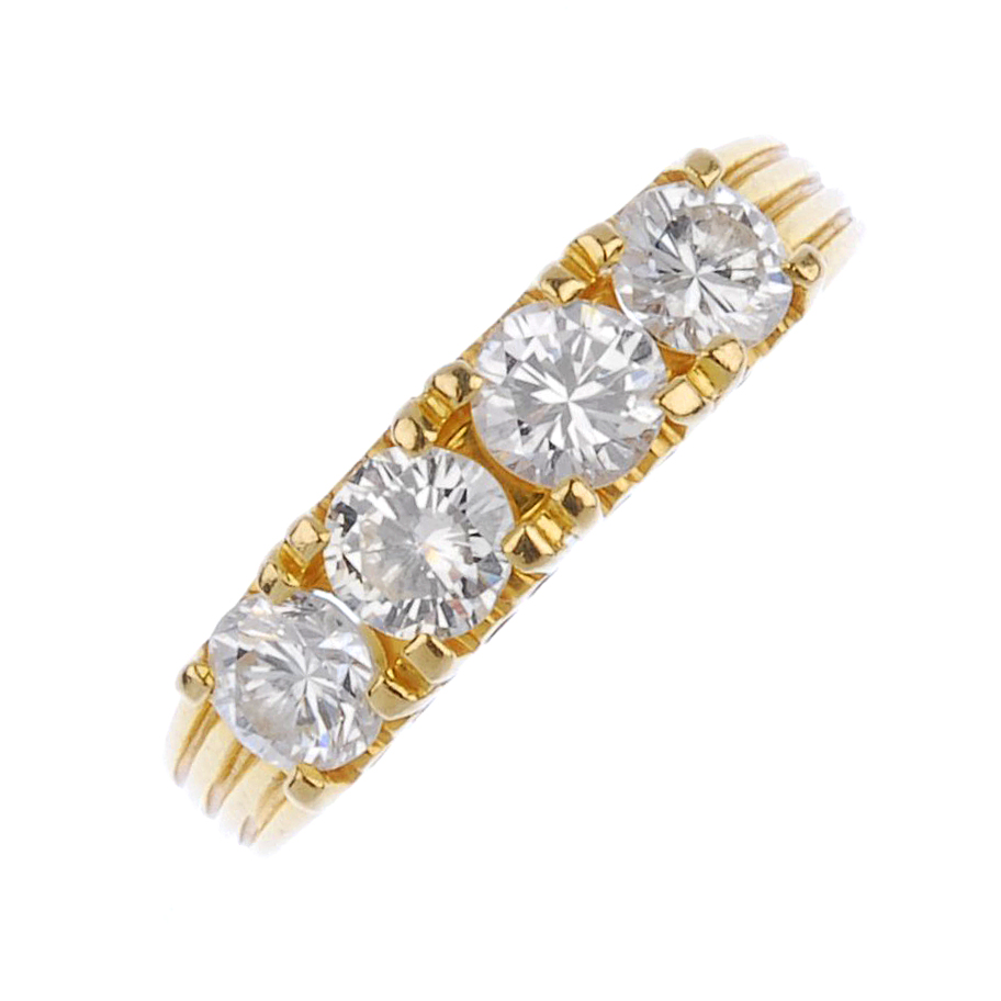 (540443-1-A) A four-stone diamond ring. The brilliant-cut diamond line, to the grooved sides and