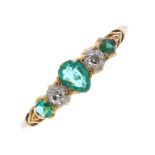 An early 20th century 18ct gold emerald and diamond ring. The pear-shape emerald, to the graduated