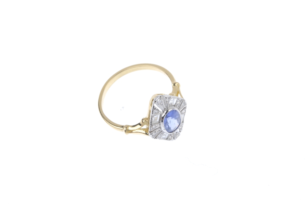 A sapphire and diamond cluster ring. The oval-shape sapphire collet, within an openwork single and - Image 3 of 4