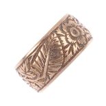 An early 20th century 9ct gold band ring. With engraved floral motif. Hallmarks for Birmingham,