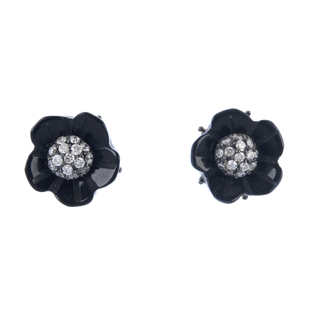 A pair of onyx and diamond floral ear studs. Each designed as a brilliant-cut diamond cluster,