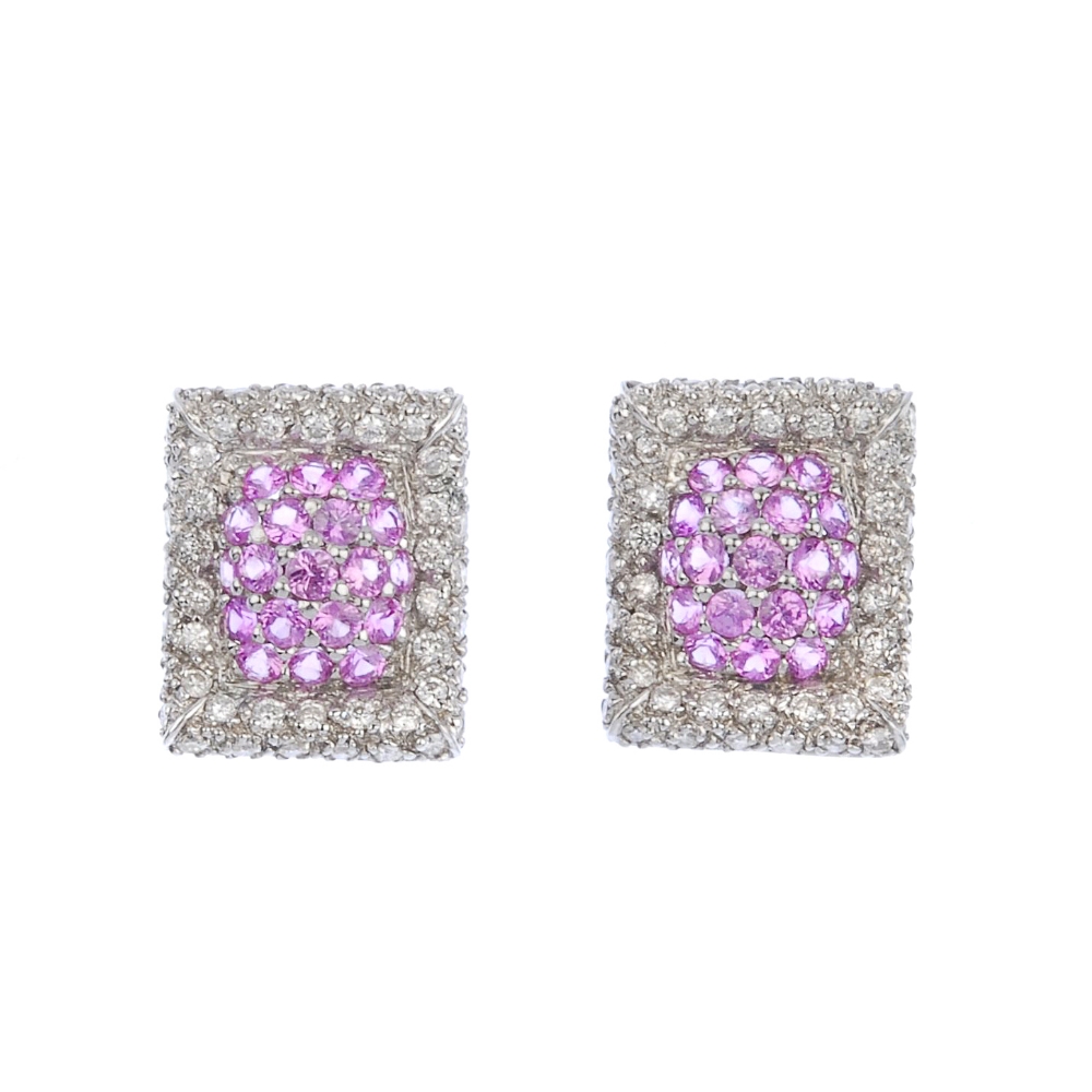 (117589) A pair of diamond and sapphire ear studs. Of curved rectangular form, the pave-set pink
