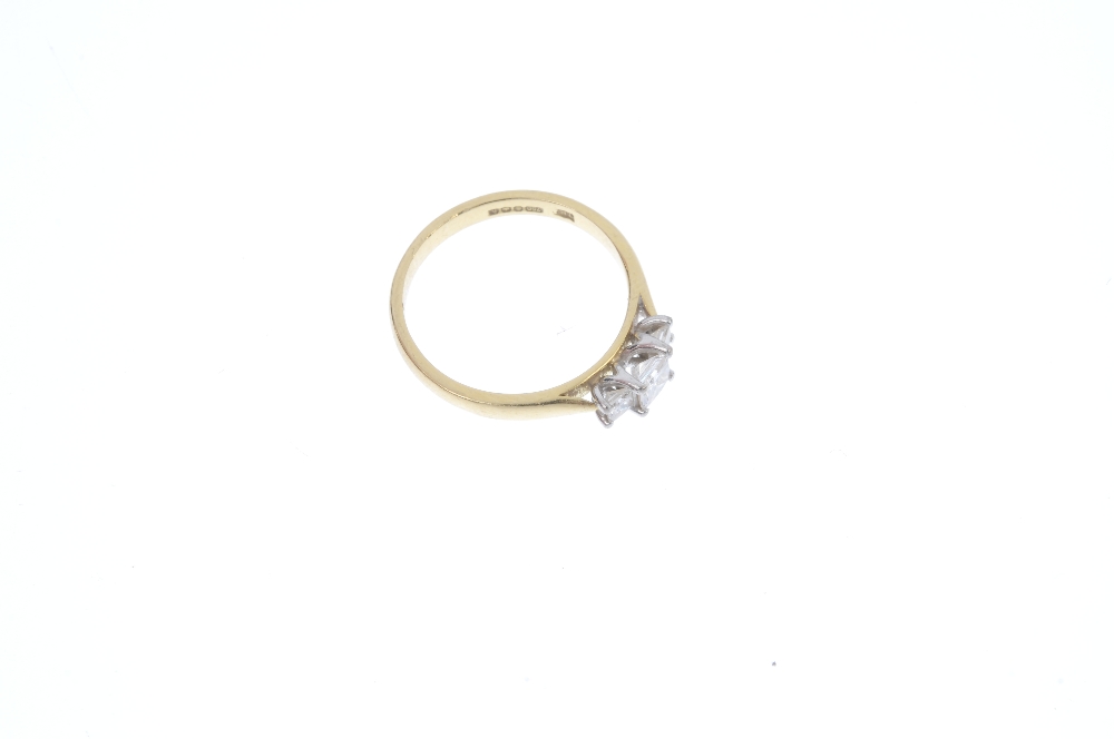 An 18ct gold diamond three-stone ring. The graduated square-shape diamond line, to the tapered - Image 3 of 4