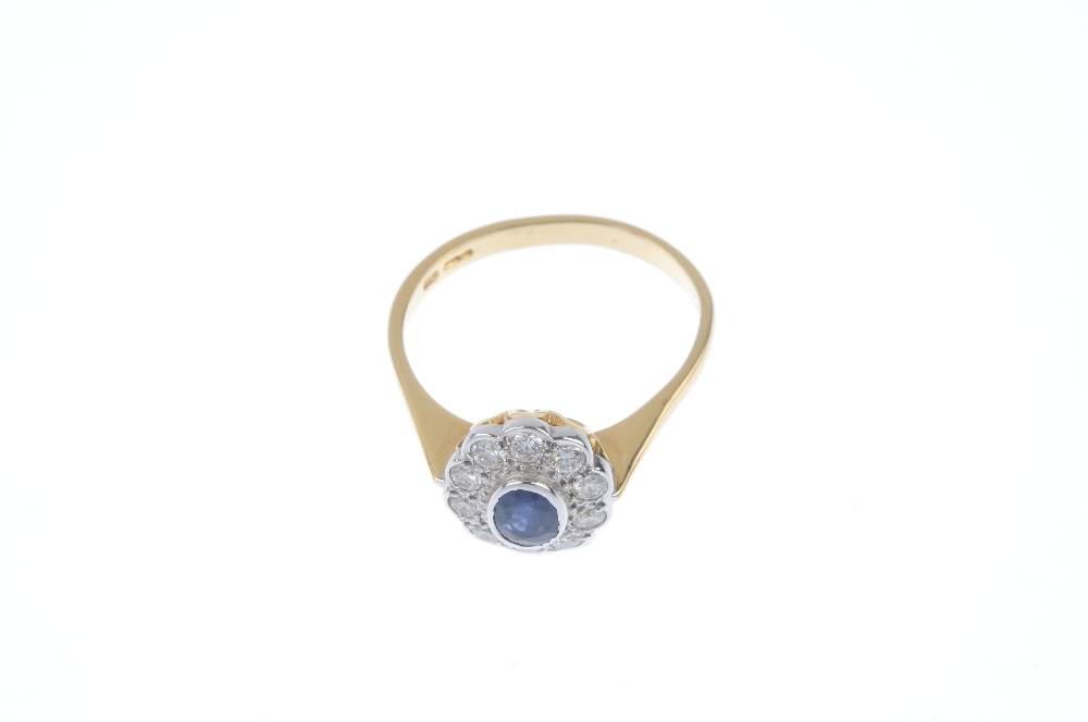 An 18ct gold sapphire and diamond cluster ring. The oval-shape sapphire, within a brilliant-cut - Image 2 of 4