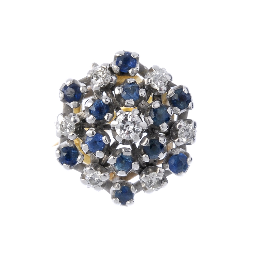 An 18ct gold sapphire and diamond cluster ring. Of openwork design, the brilliant-cut diamond,