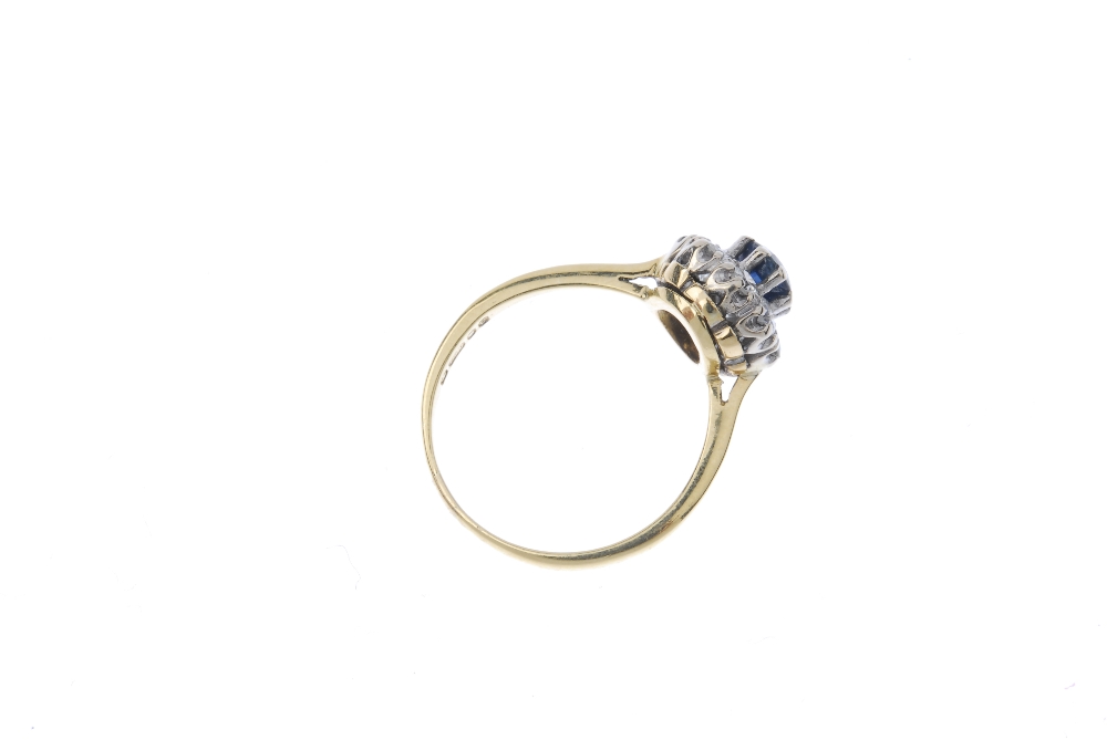 An 18ct gold sapphire and diamond cluster ring. The circular-shape sapphire, within a brilliant- - Image 4 of 4