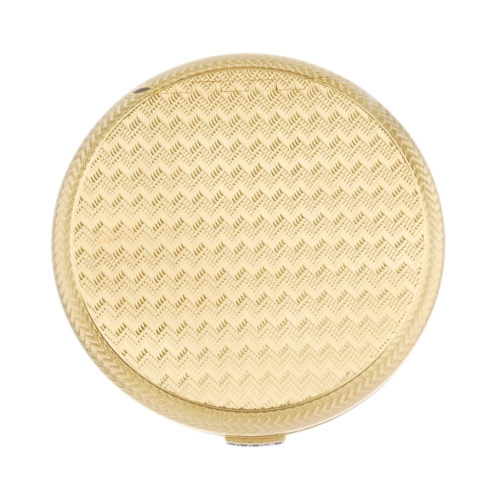 (543021-1-A) A 1950s 18ct gold powder compact. The circular-shape, engine-turned case, with