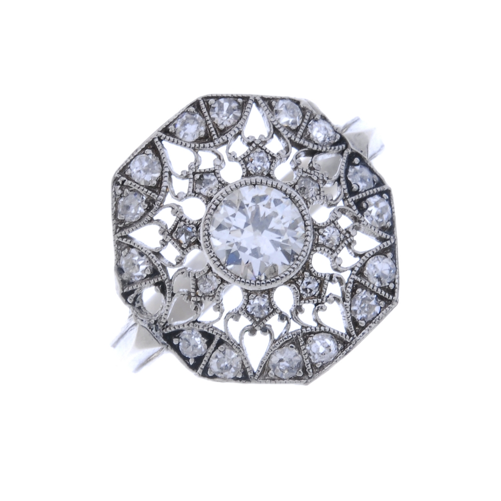 A diamond cluster ring. Of openwork design, the brilliant-cut diamond collet, within a single-cut