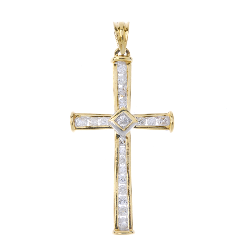 An 18ct gold diamond cross pendant. The brilliant-cut diamond, to the brilliant-cut diamond