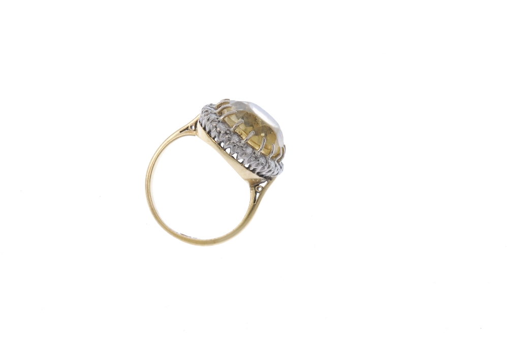 A citrine and diamond cluster ring. The oval-shape citrine, within a brilliant-cut diamond surround, - Image 4 of 4