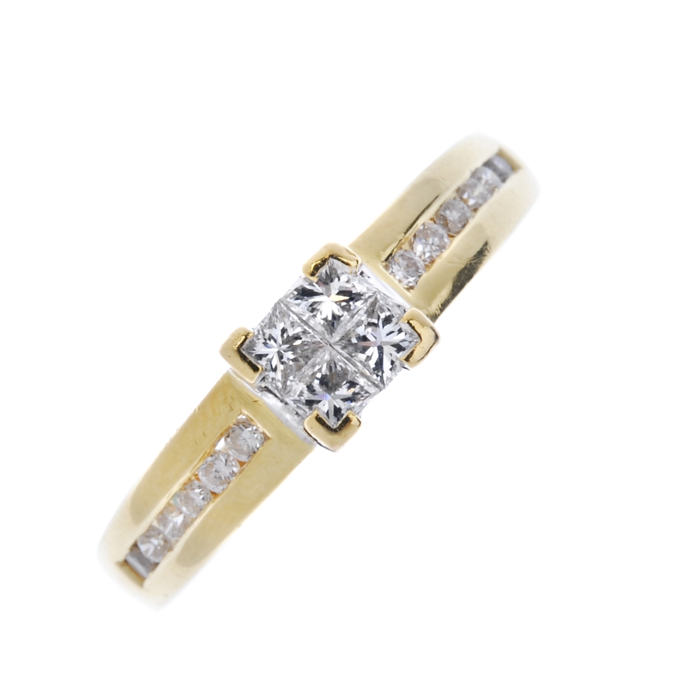 An 18ct gold diamond ring. The square-shape diamond panel, to the brilliant-cut diamond line