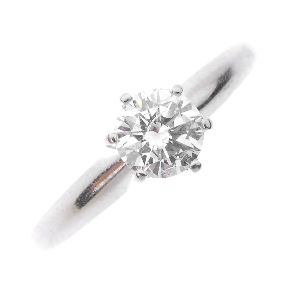 A 14ct gold diamond single-stone ring. The brilliant-cut diamond, to the plain band. Estimated