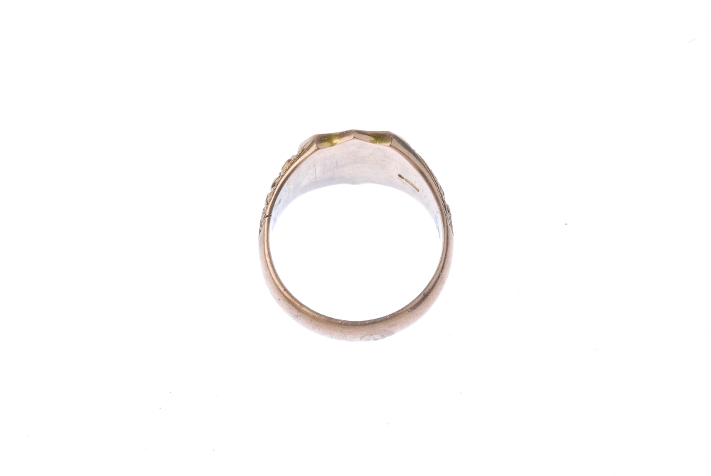 An early 20th century 9ct gold signet ring. The shield-shape panel, to the floral sides and plain - Image 4 of 4