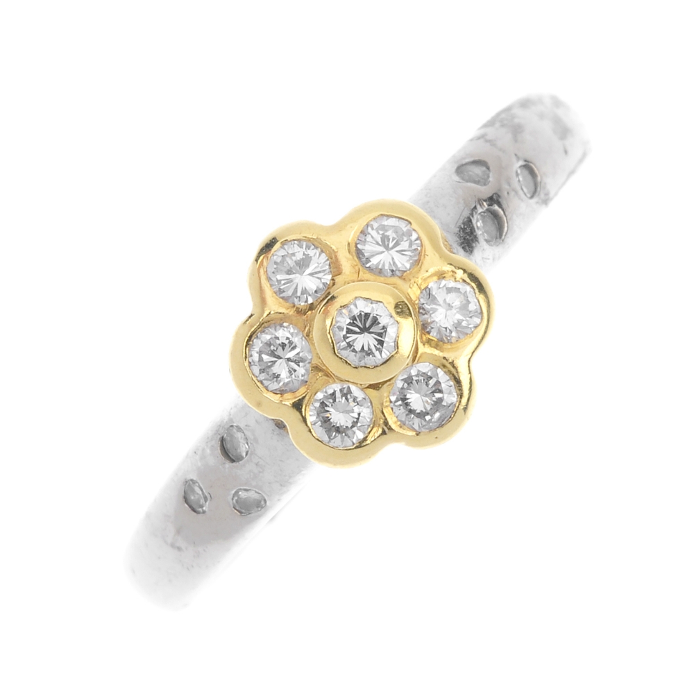 An 18ct gold diamond floral cluster ring. The brilliant-cut diamond collet, within a similarly-cut