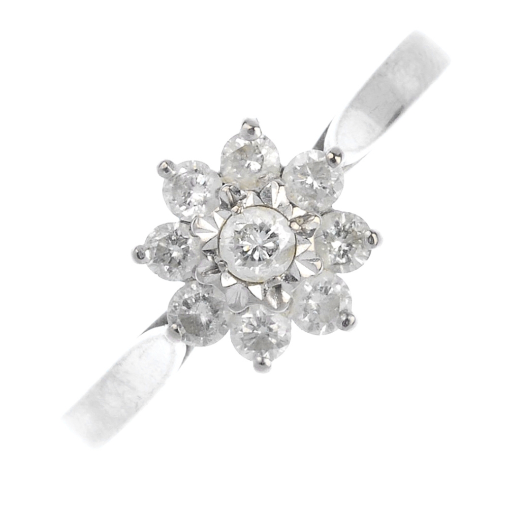 (57565) An 18ct gold diamond cluster ring. Of floral design, the brilliant-cut diamond cluster to