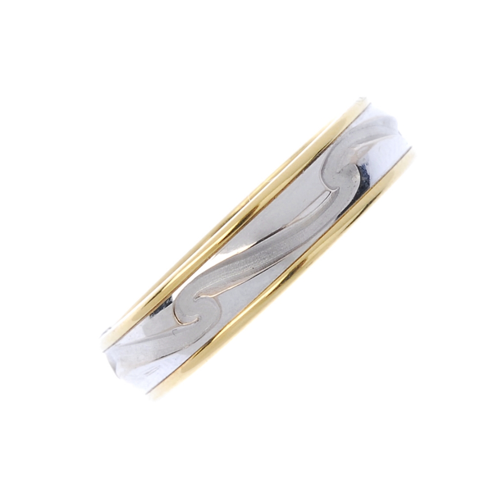 An 18ct gold colour band ring. Of bi-colour design with scrolling motif hallmarks for Birmingham.