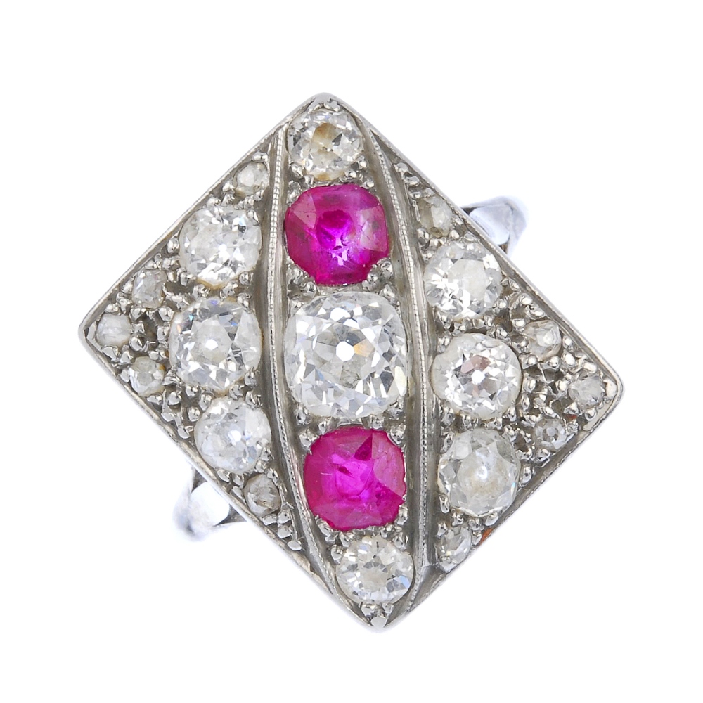 (137392) A diamond and ruby dress ring. Designed as a rectangular-shape panel of old-cut diamonds