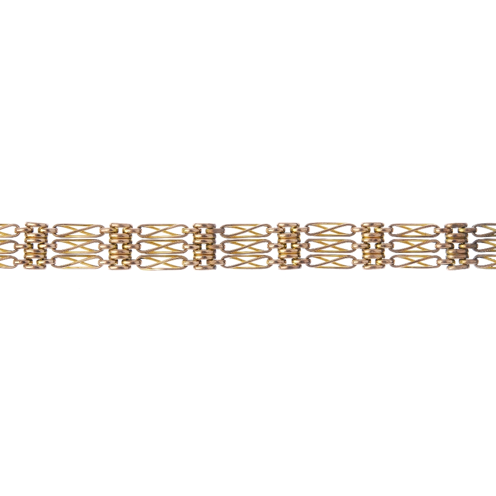 An early 20th century 9ct gold bracelet. Designed as a series of fancy gate-links and brick-links,