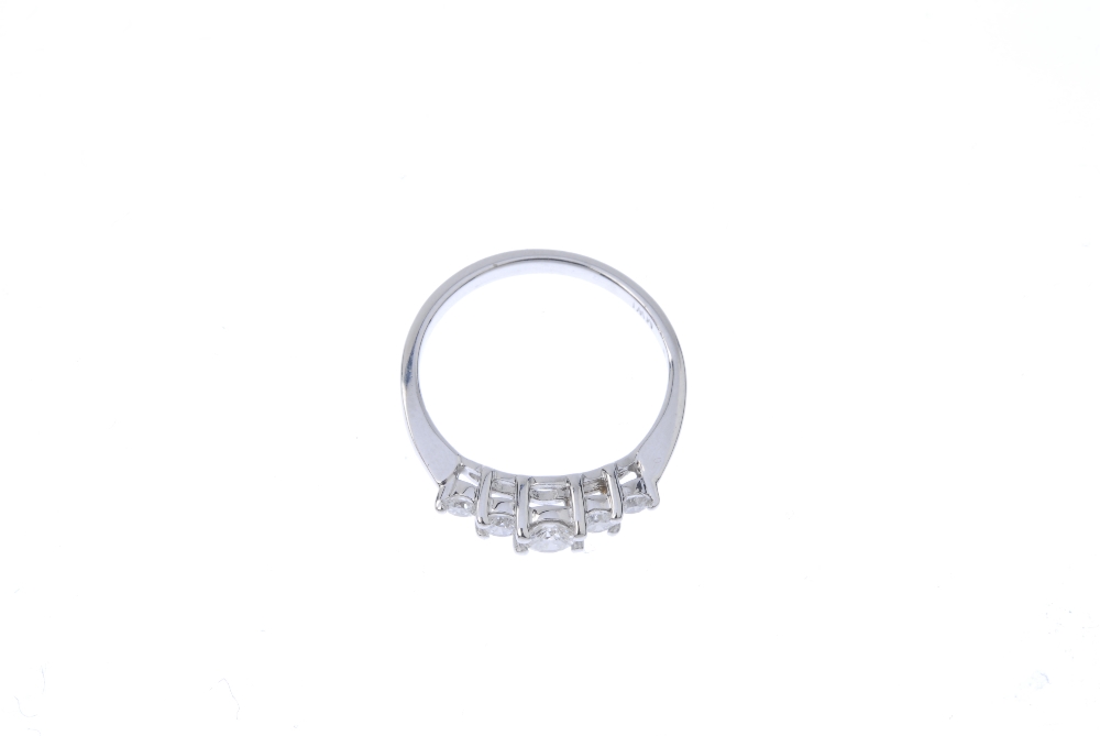 A diamond five-stone ring. The graduated brilliant-cut diamond stepped line, to the tapered - Image 2 of 4