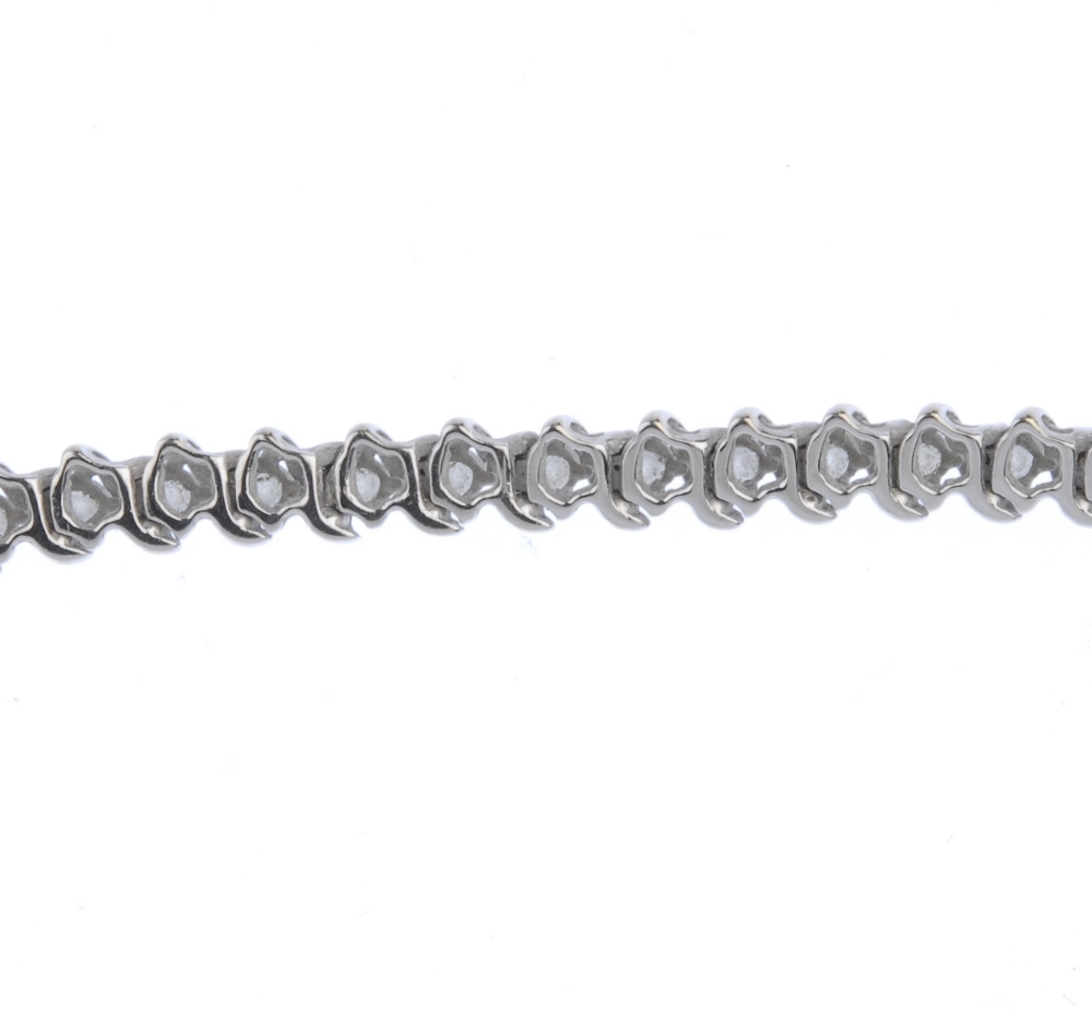 (539726-2-B) A diamond bracelet. The brilliant-cut diamond line, with scrolling spacers, to the - Image 3 of 3